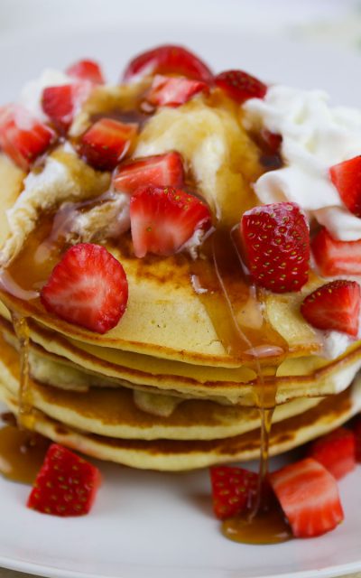 Pancakes Smothered in Strawberries and Whipped Cream for a Crowd